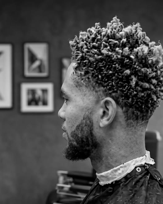 Textured curls over a high fade